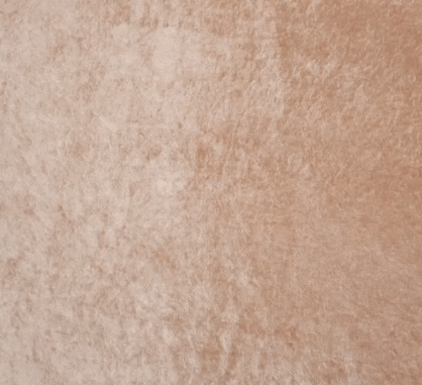 Close-up view of a soft, light brown, textured velvet fabric with a slightly shiny and uneven surface.